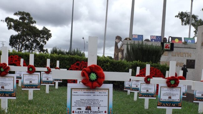 Mic Noble’s white crosses at the Logan war memorial, where the service was cancelled but he organised a video tribute. (AAP/Image Sarah Marshall)