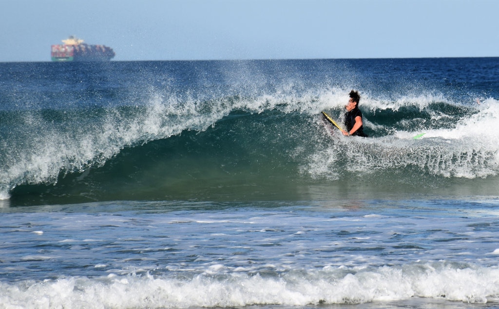 Surfers and bodyboard riders making the most of the waves at Kawana on the weekend. Picture: Mark Furler