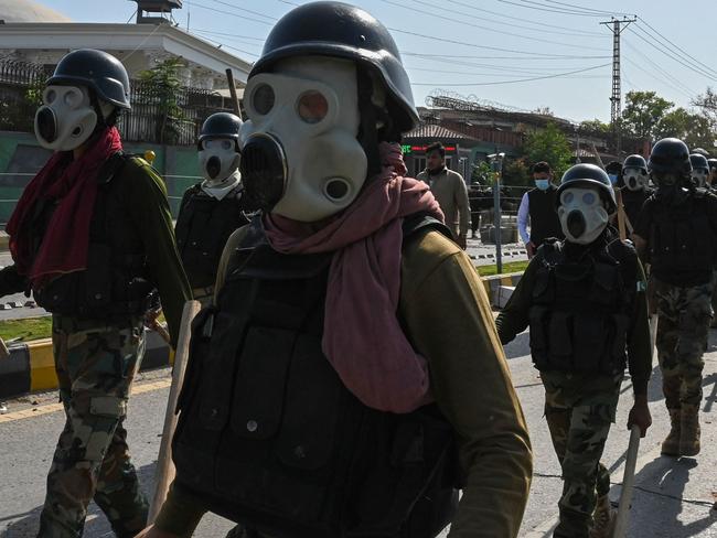 Security personnel move towards Pakistan Tehreek-e-Insaf (PTI) party activists and supporters of former Pakistan's Prime Minister Imran. Picture: AFP