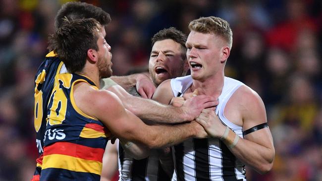 Crows Bryce Gibbs and Richard Douglas tangle with Collingwood’s Jamie Elliot and Adam Treloar. Picture: David Mariuz/AAP