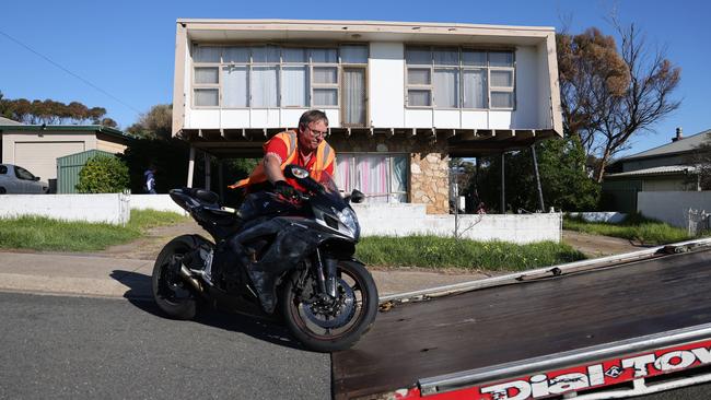 A motorbike is removed after a standoff and search at a property in Christies Beach. Picture: NewsWire / David Mariuz