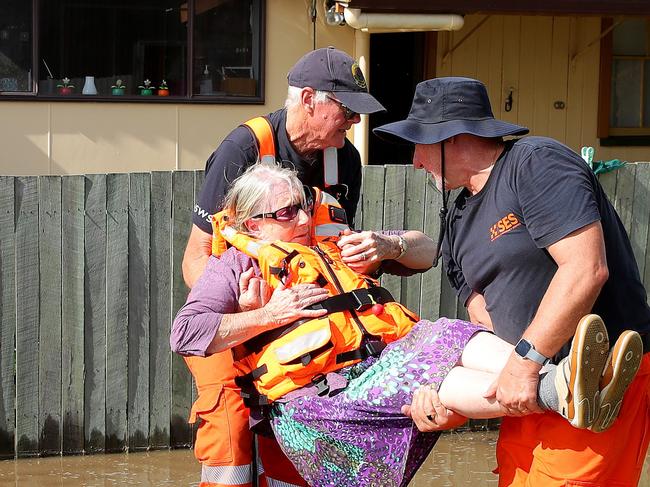 Dawn Saint is lifted out of the SES punt after being rescued from her house in Brushgrove near Maclean. Picture: Toby Zerna