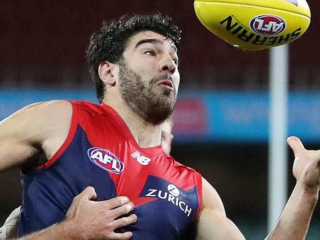 AFL - Sunday, 9th August, 2020 - Melbourne v North Melbourne at the Adelaide Oval. Melbourne's Christian Petracca  tries to control the ball from North Melbourne's Luke McDonald Picture: Sarah Reed