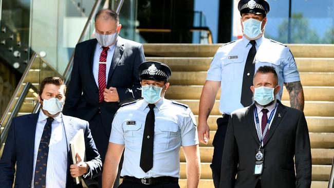 Constable Zachary Schembri (front centre) &amp; Constable Shane Warren (back right) leave the Townsville Courthouse after giving evidence at the inquest. Pictured with Gilshenan &amp; Luton Legal Practice lawyers and Queensland Police Union representative. Picture: Alix Sweeney