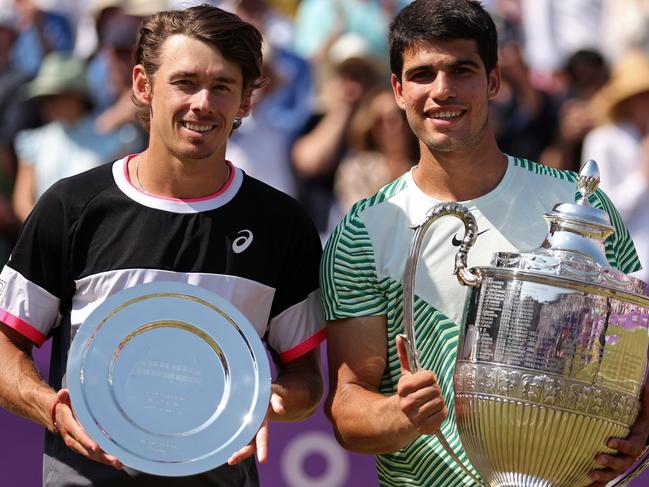 LONDON, ENGLAND - JUNE 25: Runner-up, Alex De Minaur of Australia and Winner, Carlos Alcaraz of Spain, pose with their trophies after the Men's Singles Final match on Day Seven of the cinch Championships at The Queen's Club on June 25, 2023 in London, England. (Photo by Julian Finney/Getty Images)