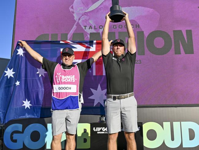 ADELAIDE, AUSTRALIA - APRIL 23: Talor Gooch of the RangeGoats holds up the LIV Golf trophy with his Australian caddie after winning the day three of Liv Golf Adelaide at The Grange Golf Course on April 23, 2023 in Adelaide, Australia. (Photo by Mark Brake/Getty Images)