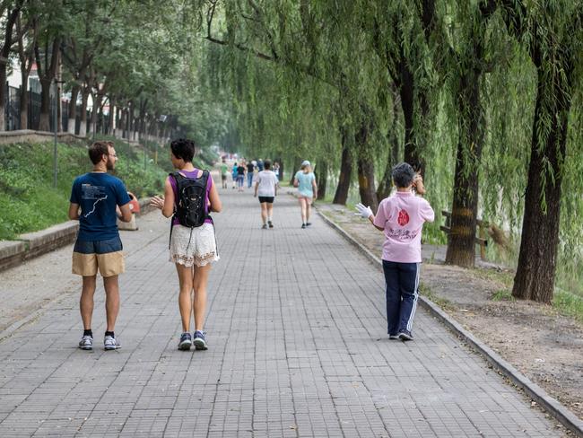 Production co-ordinator Brendan Taylor (left) walks with Alison Pratt (SSO percussionist) beside a canal. Pic: Daniela Testa.