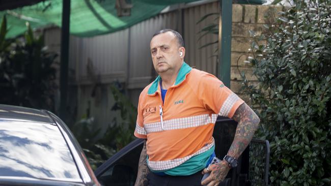 A man arrives at Dick Caine’s home after the former swim coach was charged with historical sex abuse charges. Picture: Liam Mendes