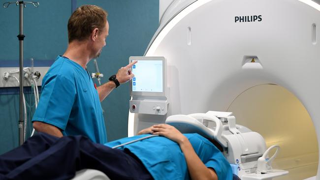 Operators Ian Reynolds and Nikki De Leon demonstrate a new next generation Ingenia Ambition 1.5T MRI machine at Nepean Hospital in Sydney, Monday, March 9, 2020. (AAP Image/Joel Carrett) NO ARCHIVING