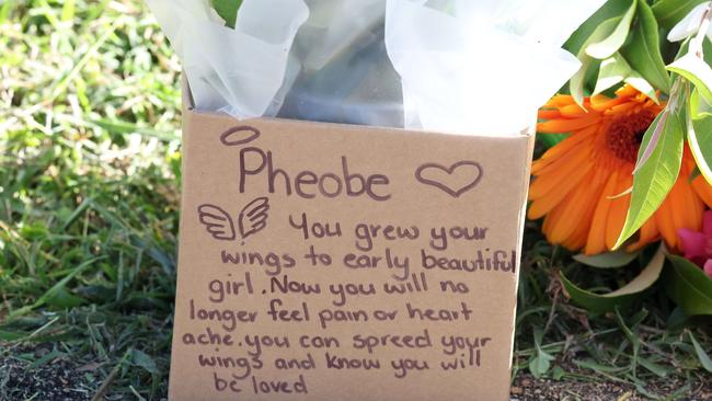 Floral tributes and note outside of Phoebe BishopÃ•s share house in Gin Gin. Picture: Liam Kidston.
