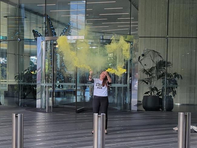 The protesters set off yellow flares outside the building as staff evacuated.