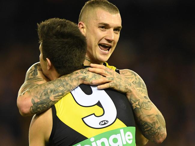 Dustin Martin (right) and Trent Cotchin of the Tigers react after Cotchin kicked a goal during the Round 11 AFL match between the North Melbourne Kangaroos and the Richmond Tigers at Etihad Stadium in Melbourne, Saturday, June 3, 2017. (AAP Image/Julian Smith) NO ARCHIVING, EDITORIAL USE ONLY