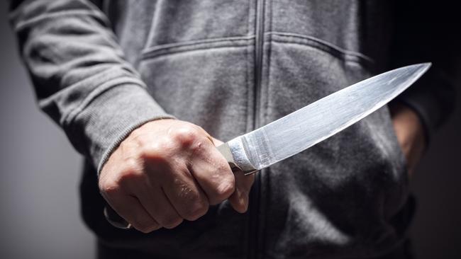 A student was spotted roaming the school grounds with a knife.