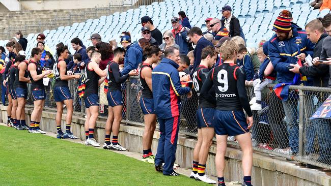 Crows players sign autographs for waiting fans at Crows training at West Lakes. Picture: Bianca De Marchi