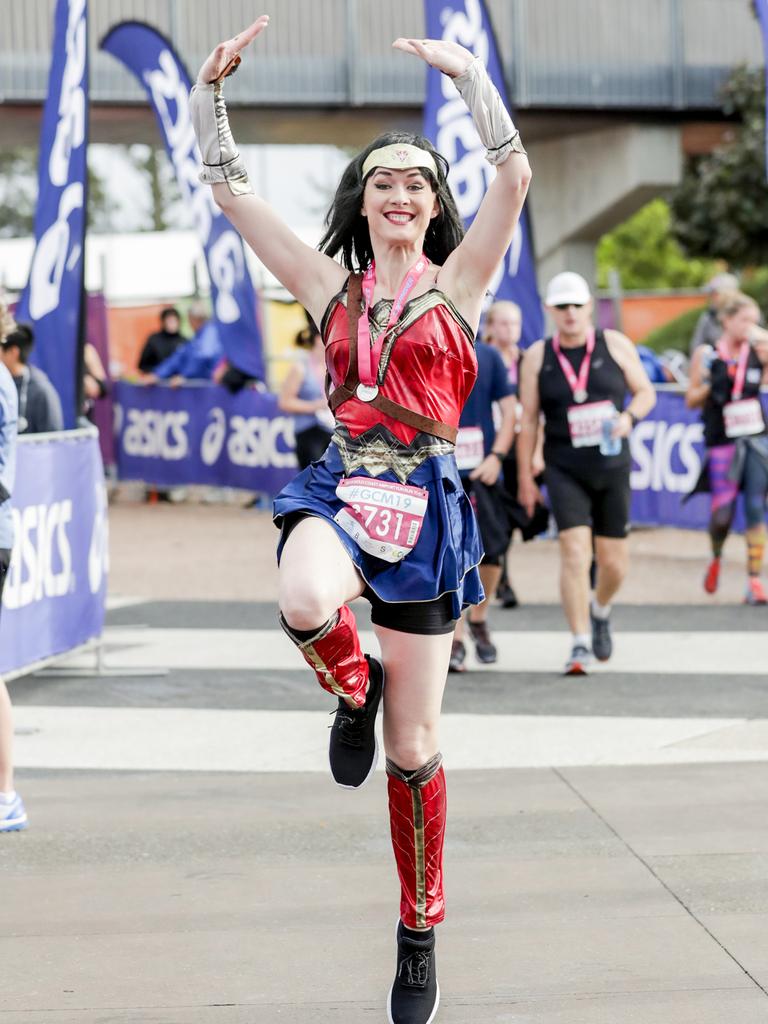 Wonder Woman Victoria Letherby jumps for joy on finishing the Gold Coast Airport Fun Run. Picture: Tim Marsden.