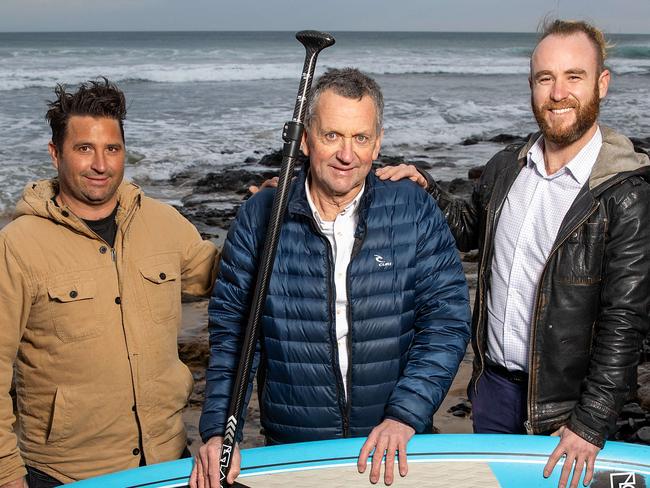 Stephen Fullarton had a stroke while on his stand-up paddle board in the surf off Phillip Island. He was rescued by locals and is undertaking an amazing recovery. Stephen is pictured catching up with the two men who pulled him from the surf along the rugged coastline, Larson Henderson (tan jacket) and Daniel Seale (leather jacket). Picture: Mark Stewart