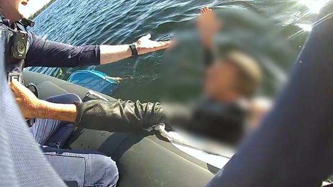 Police have released video of a daring rescue near a popular dolphin watching spot after a man was found clinging to a sunken boat.  Picture: Queensland Police