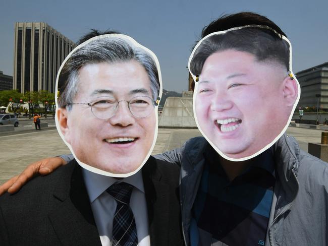 South Korean activists wearing masks of Moon Jae-in (L) and Kim Jong-un (R) pose in Seoul. Picture: AFP/Jung Yeon-je