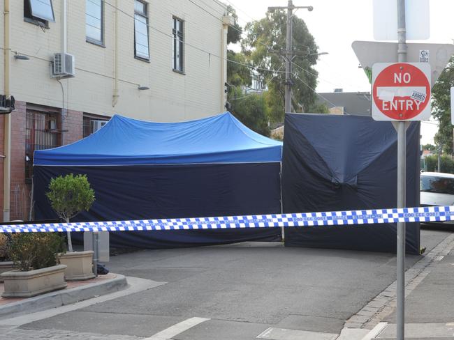 Police officers investigating the circumstances surrounding the death of a man in Brunswick East. Police were called to St Phillip Street around 3am where the man's body was located on the footpath in Melbourne, Tuesday, March. 15, 2016. (AAP Image/Mal Fairclough) NO ARCHIVING