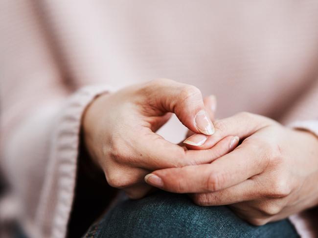 Cropped shot of a woman sitting on a sofa and feeling anxious