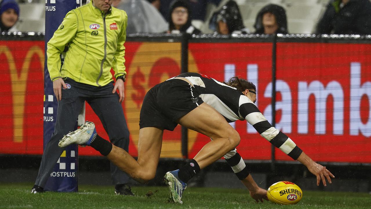 Darcy Moore rushes a behind … Picture: Getty Images