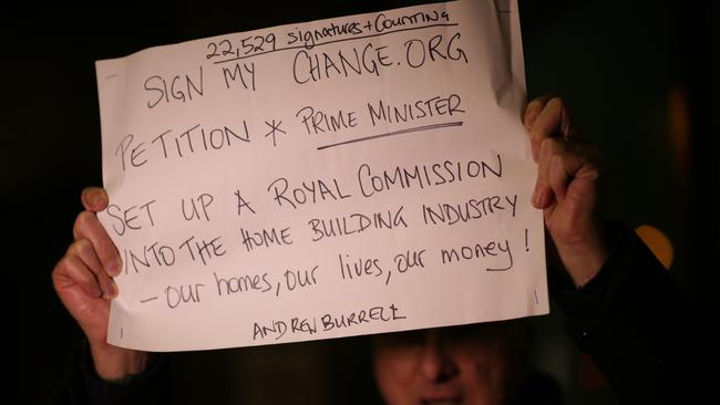 Mascot Towers resident Andrew Burrell calling for a royal commission into the construction industry, outside the extraordinary meeting of the owners corporation last month. Picture: Christian Gilles