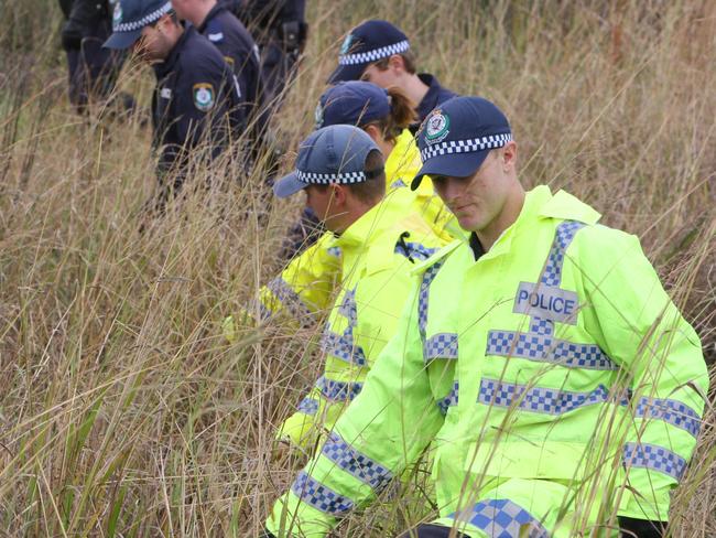 Police search nearby bushland for clues into the murder of Wyong High School teacher Amanda Carter.