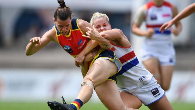 Katie Brennan lays a tackle on Crow Chelsea Randall.