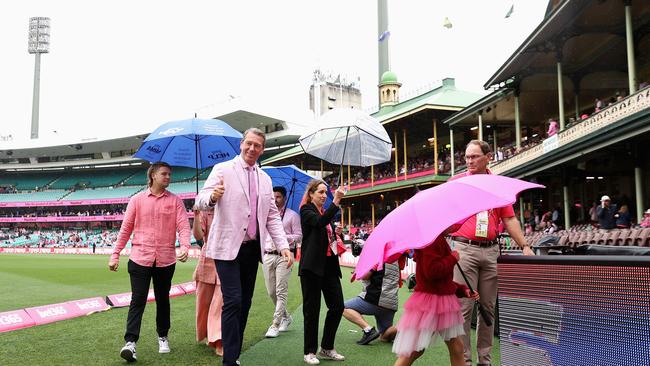 Former Australian cricketer Glenn McGrath attends the Jane McGrath Day - with the umbrellas an essential addition. Picture: Getty