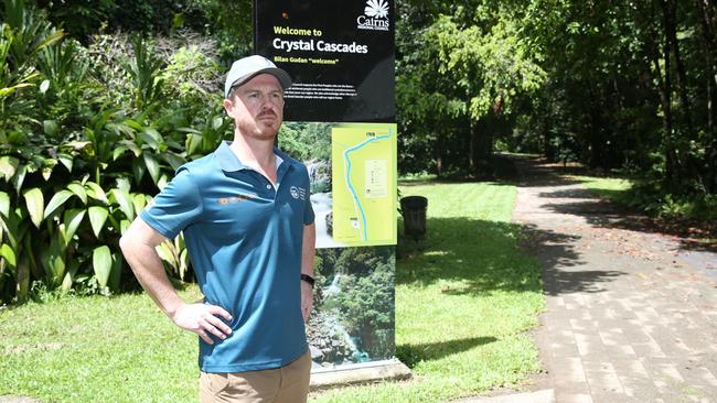 Queensland Parks and Wildlife Service regional director Matthew Brien stands by visitor information signage at Crystal Cascades. Picture: Arun Singh Mann