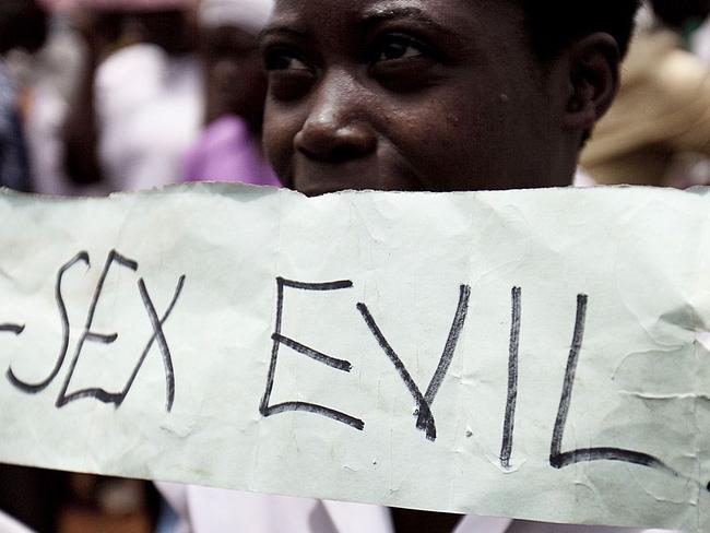 Photo taken on February 14, 2010 shows Ugandans taking part in an anti-gay demonstrationy at Jinja, Kampala. A Ugandan pastor seeking to bolster Uganda's anti-gay laws which already make homosexuality punishable by life imprisonment screened gay porn in a packed Kampala church Wednesday February 17, 2010 in a bid to drum up support that was attended by around 300 supporters after plans for a "million-man march" were thwarted by police. AFP PHOTO/TREVOR SNAPP