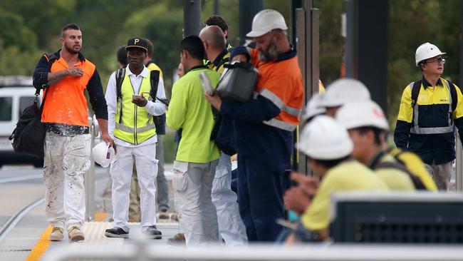 Workers walk off the job after an union meeting at the RAH site. Picture: Calum Robertson