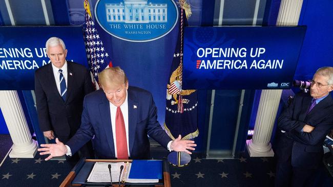 US President Donald Trump flanked by US Vice President Mike Pence and Director of the National Institute of Allergy and Infectious Diseases Anthony Fauci, right, outlines his blueprint to restart the US econoy. Picture: Mandel Ngan/AFP