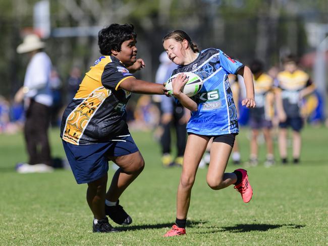 Francis Fuller of Rockville State School gets a touch on Keeley Van der Watt of Middle Ridge State School in the inaugural Primary Interschools Reconciliation Touch Carnival hosted by Glenvale State School, Wednesday, May 28, 2025. Picture: Kevin Farmer