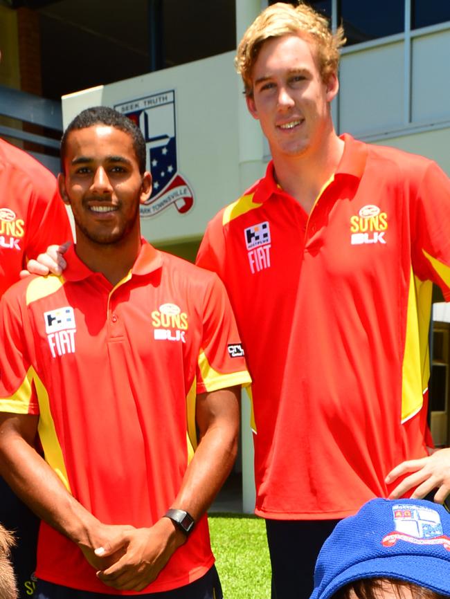 Suns players Touk Miller and Tom Lynch at a footy clinic.