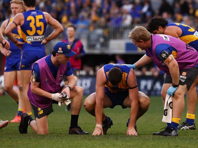 Jeremy McGovern of the Eagles goes down during the match against Hawthorn. Picture: Jack Foley/AFL Photos via Getty Images.