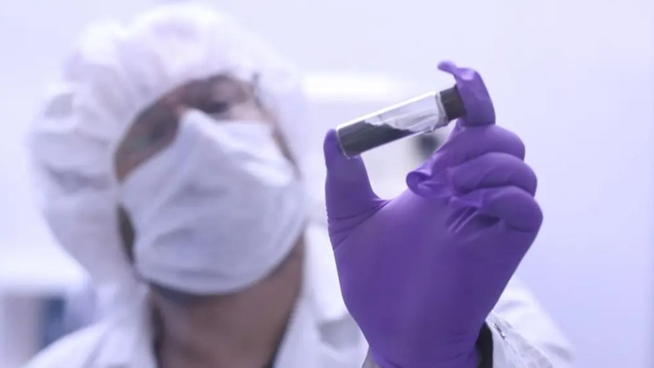 NASA scientist Jason Dworkin holds up a vial that contains part of the sample from asteroid Bennu delivered to Earth by NASA’s OSIRIS-REx mission in 2023. Picture: NASA/James Tralie