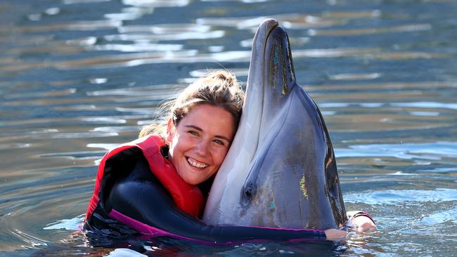 Janine Koeppen from Hamburg, Germany enjoying a swim with dolphin "Kiama" at Sea World. Picture: Adam Head