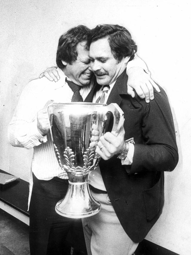 North melbourne president Allen Aylett hugs coach Ron Barassi after the Kangas won the 1975 flag.