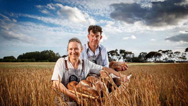 Emily Salkeld with husband Chris Duffy from Small World Bakery among some of their wheat crops at Langhorne Creek. Picture: Matt Turner