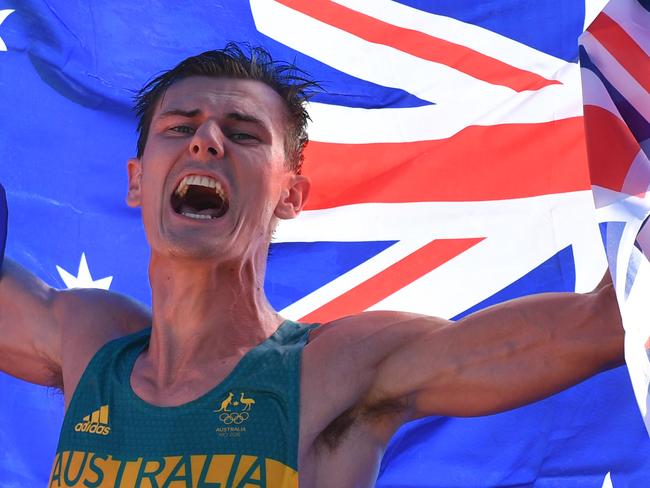 Bronze medallist Australia's Dane Bird-Smith celebrates after the Men's 20km Race Walk during the athletics event at the Rio 2016 Olympic Games in Pontal in Rio de Janeiro on August 12, 2016.   / AFP PHOTO / Ben STANSALL