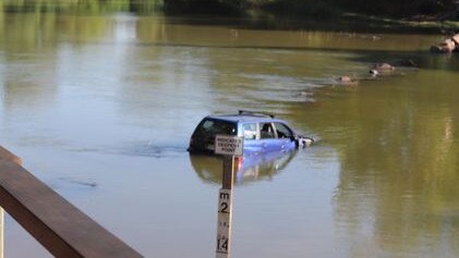 People travelling in this now waterlogged Subaru had to be rescued overnight when its became stuck on Cahills Crossing. Commuters from both sides have been forced to wait until the tide drops enough for the car to be removed. Picture: Charlotte Ruth