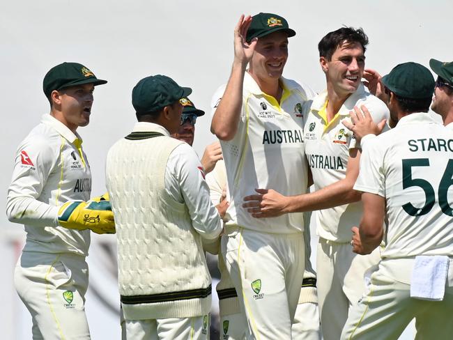 Australia's Pat Cummins (3R) celebrates with teammates after dismissing India's Ajinkya Rahane (unseen) for 89. Picture: AFP