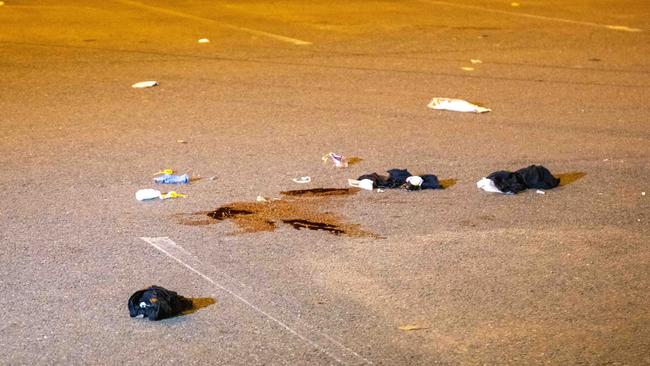 Images from the scene show blood stains on the concrete and clothes scattered on the ground. Picture: Dean Asher