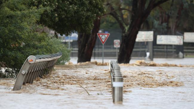 Flood water from the Traralgon Creek over Franklin St in Traralgon on June 10. The local football club was among those affected by the flood. Picture: David Caird