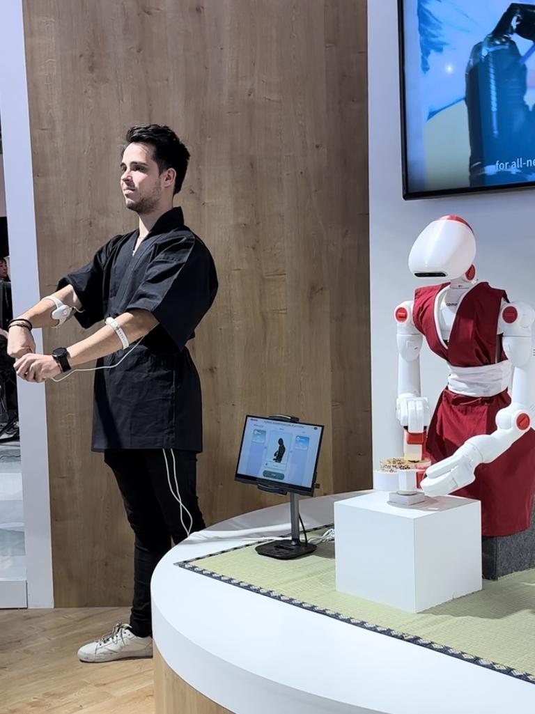 A demonstration of human augmentation technology which allows robots to copy humans.