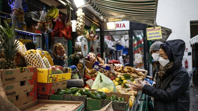 People shop in a covered market in downtown Rome. Picture: AP