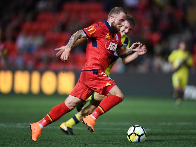 United’s Daniel Adlung runs with the ball against the Mariners at Coopers Stadium in February. Picture:  Mark Brake / Getty