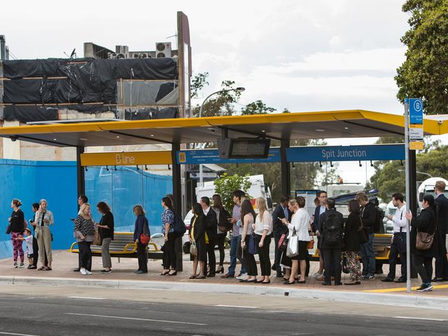 Commuters waiting to hop a bus to the city at Spit Junction.