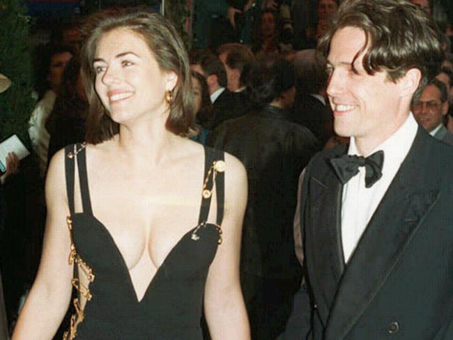 11/05/1994. Hugh Grant with actress Elizabeth Hurley (Liz Hurley), wearing a dress designed by Gianni Versace, in this Dec94 picture in London. Four weddings and a funeral. Premiere. (AP Photo/Mike Stephens)*UNITED KINGDOM OUT*